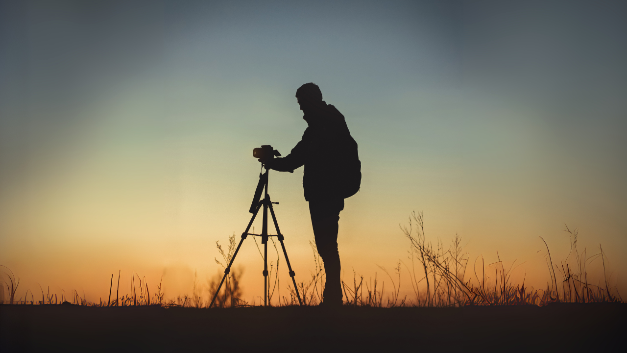 silhouette-de-photographe-avec-trépied-au-coucher-du-soleil-en-paysage-naturel
